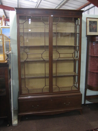 A Georgian mahogany display cabinet with moulded cornice,  the interior  fitted  adjustable  shelves  enclosed  by  astragal   glazed  panelled  doors,  the  base fitted 2 brushing slides  above  1  long drawer, raised on splayed bracket feet 52"