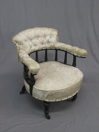 An   Edwardian  ebonised  tub  back  chair  with  bobbin   turned decoration, upholstered in white material