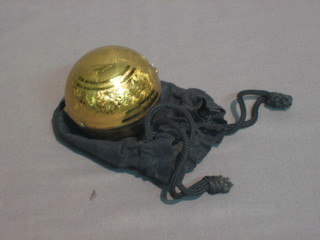 A gilt metal globe shaped powder compact