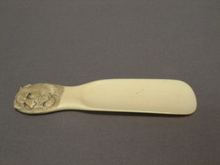 A carved ivory shoe horn the handle carved a tiger 5"
