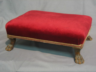 A 20th Century Georgian style mahogany stool, raised on  carved paw feet, upholstered in red material 15"