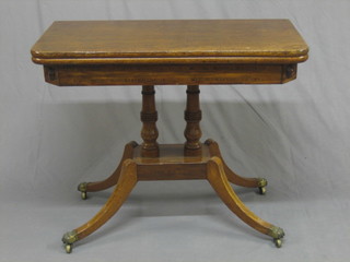 A  Georgian mahogany D shaped tea table, raised on  2  columns with  platform  base  and  scrolled feet ending  in  paw  caps  and castors 36"