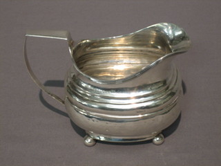 A Georgian silver cream jug raised on bun feet 4 ozs