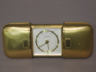 A 1940's German Estyma travelling clock contained in a gilt case