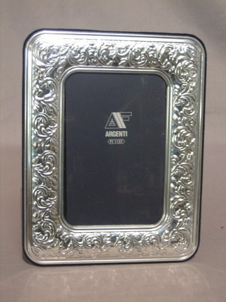 A  modern  embossed  silver  easel  photograph  frame  9"  x   7"