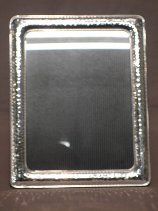 A  modern embossed silver easel photograph frame 10" x 7  1/2"