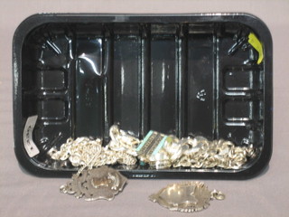 A  heavy  silver  bracelet, 2 silver chains, 2  silver  watch  chain medallions,  a  silver  ring  and a  silver  and  enamelled  pendant