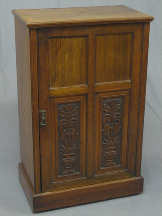 An Edwardian walnut music cabinet enclosed by a panelled  door 24"