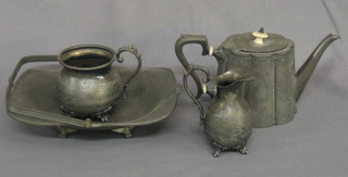 An  oval  Britannia metal teapot, a planished pewter  cake  basket with swing handle, a Britannia metal cream jug and a sugar  bowl