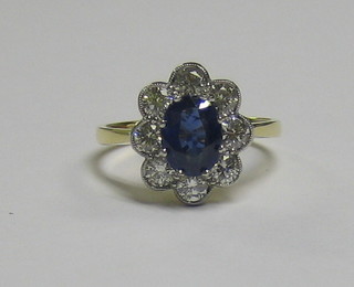 A lady's 18ct gold dress/engagement ring set an oval cut sapphire surrounded by 8 diamonds