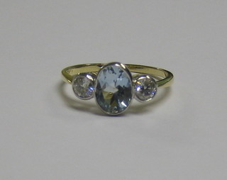 A   lady's  18ct  gold  dress/engagement  ring  set  an   oval   cut aquamarine supported by 2 diamonds