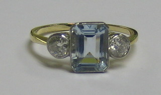 A   lady's  18ct  white  gold  dress  ring  set  a   rectangular   cut aquamarine supported by 2 diamonds