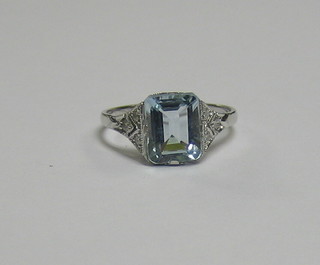 A  lady's gold dress ring set a rectangular cut aquamarine  and  6 diamonds to the shoulders