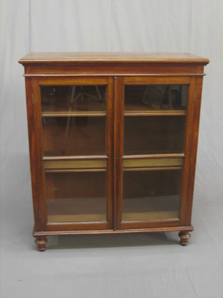 An  Edwardian walnut display cabinet, the interior  fitted  shelves enclosed by glazed panelled doors, 34"