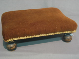 A  rectangular Victorian mahogany foot stool, raised on bun  feet