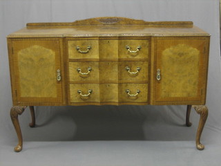 A  1950's  bleached and figured walnut  sideboard  of  serpentine outline, fitted 3 drawers flanked by a pair of cupboards, raised on cabriole supports 59"