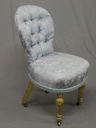 A  19th  Century  carved  gilt salon chair,  raised  on  turned  and reeded supports, upholstered in blue buttoned material