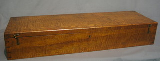 A rectangular oak cartridge box with hinged lid and brass counter sunk handles 30"