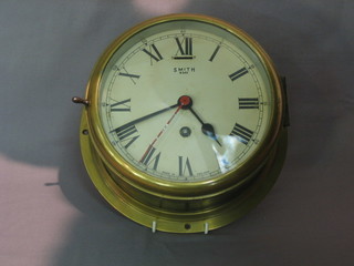 A Smith's 8 day ward room clock with painted dial, contained  in a brass case 8"