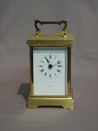 A  20th  Century battery operated carriage clock  with  enamelled dial and Roman numerals by Weiss, contained in a gilt metal case