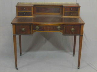 A  handsome  Edwardian walnut writing table  with  raised  super structure  to  the  back, fitted 4 short  drawers  with  inset  tooled  leather  writing  surface, above 1 bow front drawer  and  2  short  drawers, raised on square tapering supports ending in castors  40"