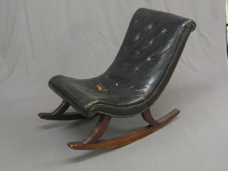 A  19th  Century  style  mahogany  rocking  armchair,  raised  on reeded runners