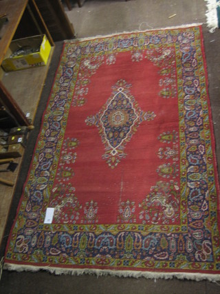 A  19th  Century  red ground Persian rug with  medallion  to  the centre within floral borders (some wear) 81" x 50"