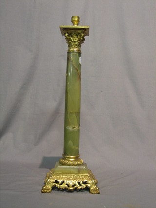 An onyx and gilt metal table lamp with Corinthian capital,  raised on a pierced gilt metal base 21"