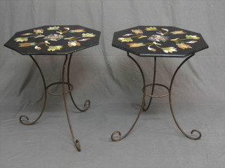 A pair of octagonal specimen marble tablets, raised on iron  bases 24"