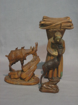 A carved wooden figure of a standing peasant woman with panier 6", a carved wooden figure of a goat 4" and 1 other 4"