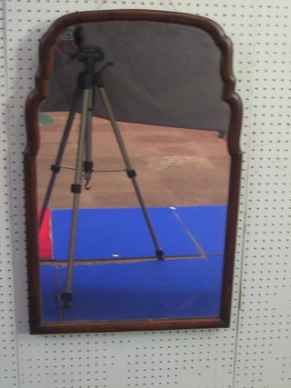 A  Queen  Anne  style  arch shaped plate  mirror  contained  in  a walnut frame 28"