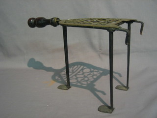 A  19th  Century  pierced brass trivet  with  wooden  handle  12"