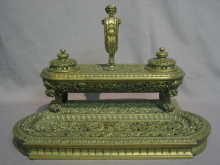 A  handsome  19th  Century  pierced  brass  twin  bottle   inkwell surmounted by a figure of a standing gentleman, (no bottles)  and pen tray  beneath 15"