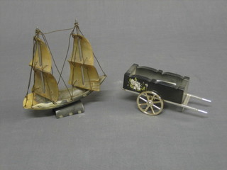 A  resin  figure of a hand cart 4" and a horn model  of  a  galleon