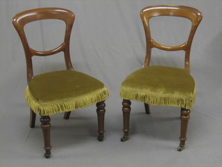A pair of Victorian walnut spoon back chairs with plain mid  rails