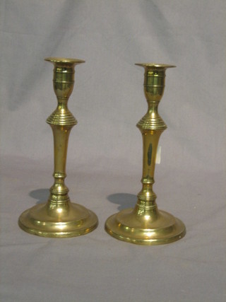 A pair of brass candlesticks with ejectors 8"
