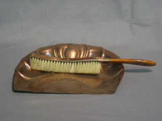 An Art Nouveau copper crumb tray and brush