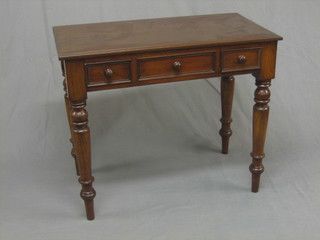 A  Victorian  mahogany  side table fitted 2 short  drawers  and  1 dummy drawer, raised on turned supports 36"