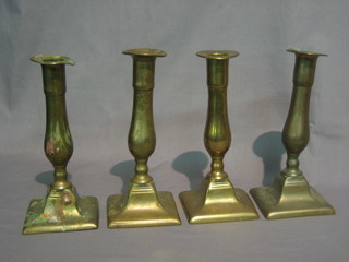 A  set of 4 19th Century brass candlesticks with square bases  and ejectors 8"