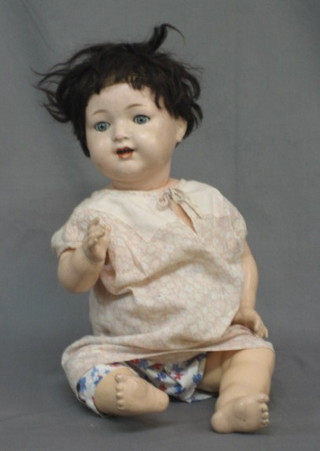 A plastic doll with open mouth, two teeth, open and shutting eyes and articulated limbs 19"