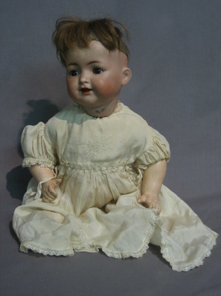 A 19th Century Simon & Halbeig porcelain doll with open mouth and open eyes, the head incised Simon & Halbeig 126