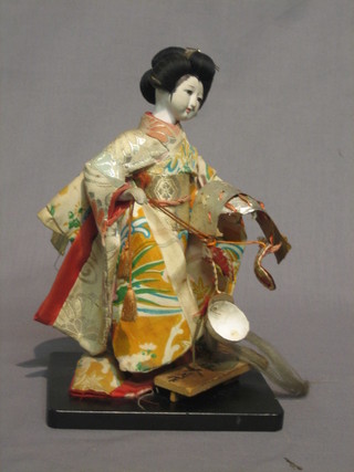 An Oriental porcelain costume doll 10"