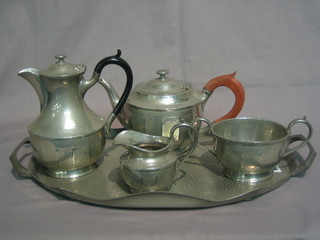 A  5  piece Hutton planished pewter tea service  comprising  oval twin  handled  tea tray, teapot, hotwater jug, twin  handled  sugar bowl and cream jug