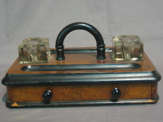 A Victorian walnut standish fitted 2 square cut glass inkwells, the base with pen receptical and fitted a drawer 12"