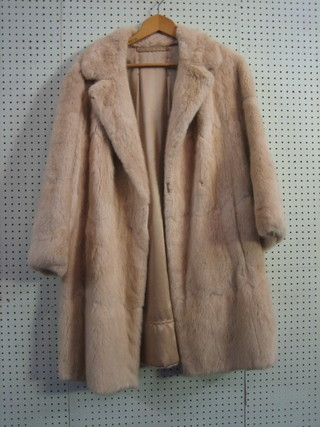 A lady's white quarter length fur coat