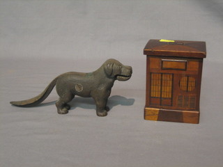 A  pair  of  metal  nut  crackers in the form of  a  dog  7"  and  a wooden money box in the form of a house 3 1/2"