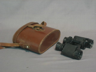 A pair of field glasses contained in a leather case