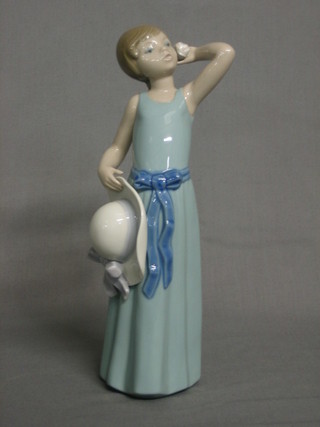 A  Lladro  figure of a standing girl wearing a blue dress  and  hat 10"
