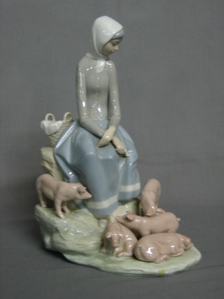 A Lladro figure of a seated lady with piglets 11"