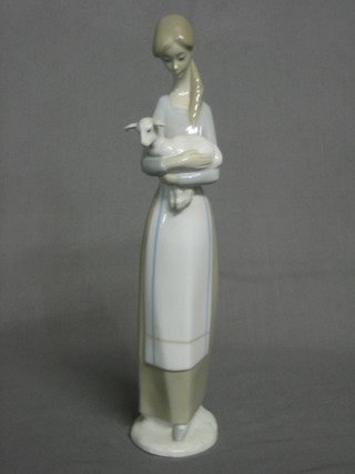 A  Nao figure of a standing girl with lamb, base  impressed  Nao 10"